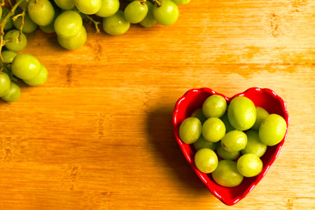 Grapes in a small red heart shaped bowl