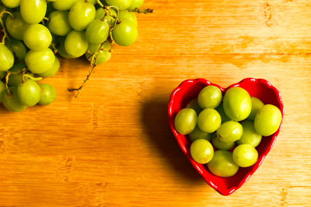 Grapes in a small red heart shaped bowl