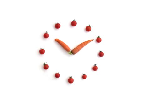 Vitamin Clock Made of Carrots and Tomatoesの写真素材