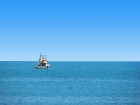 Single fishing boat in the middle of sea