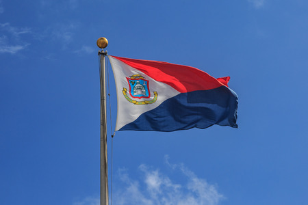 St. Marteen flag in the blue sky waving.の写真素材