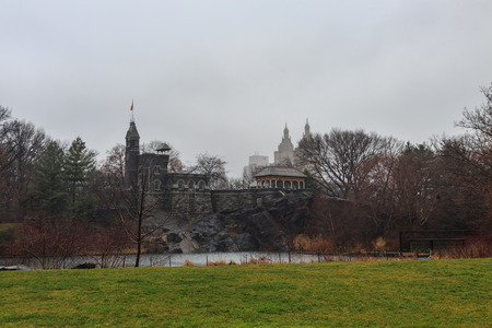 Belvedere Castle in central park, new york city during cloudy weather with skyscrapers.の写真素材