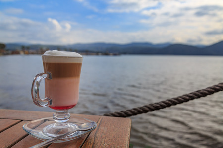 Raspberry mocha on the table with beach viewの写真素材