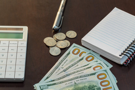 Money, calculator, pen, and notebook on the table