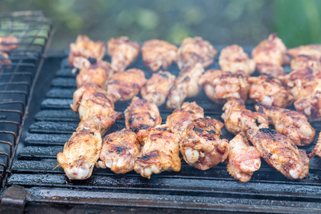 Grilling chicken wings on grillの写真素材