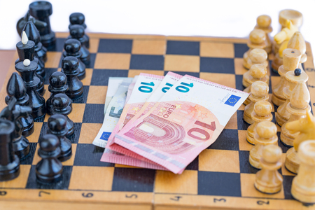 Chess components and money between themの写真素材