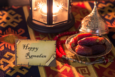 Happy ramadan on card with dates and lampの写真素材