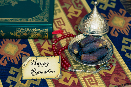 Happy ramadan text on card with dates and Qur'anの写真素材