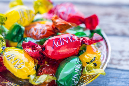 Colorful candies on plate on the vintage tableの写真素材