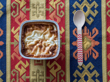 Rise pudding on traditional carpet with red spoon