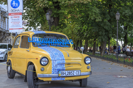 At prymorsky boulevard in Odessa, Ukraine - August 23, 2018 : An old car with ukrainian colors and traditional desings in Odessa, Ukrianeのeditorial素材