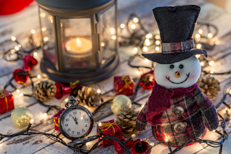Snowman with pocket watch, christmas decorations and lightsの写真素材