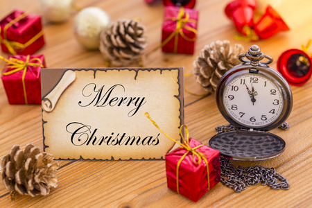 Greeting card for new year or christmas with pocket watch and christmas decorationsの写真素材