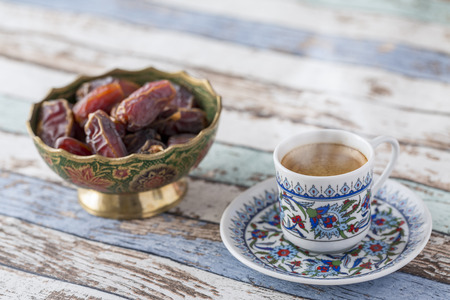 Turkish coffee and dates on turquoise table side viewの写真素材
