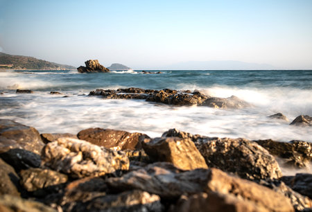 Photographing the waves that hit the rocks in a stormy weather with a long exposure