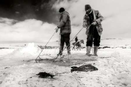 fishermen and sledding in the frozen lake Cildirの写真素材