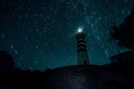SarpÄ±ncÄ±k Lighthouse, which was established in 1938, is a veteran lighthouse that has not stopped serving since then. SarpÄ±ncÄ±k Lighthouse, which is powered by solar energy, is 97 meters high from the sea and its visibility is 12 miles. SarpÄ±ncÄ±k Lighthouse greets us with its white appearance in front of the blue of the Aegean Sea in the lonely region of Karaburun. This lighthouse has a very cute view with its 12-meter white tower and the lighthouse in the garden.の写真素材