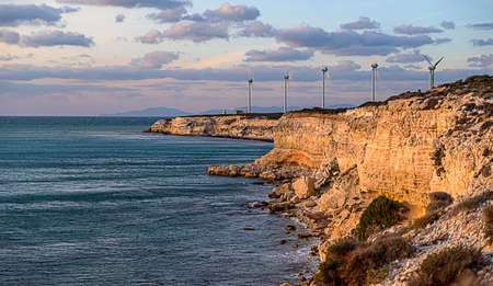 Bozcaada sunset presents a different visual every day with wind roses and lighthouse.の写真素材