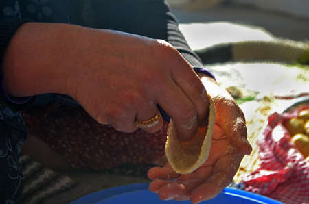 woman making kibbeh with her handの写真素材