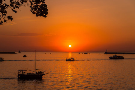 Bright sunset, quiet bay, walk on a yacht at sunsetの写真素材