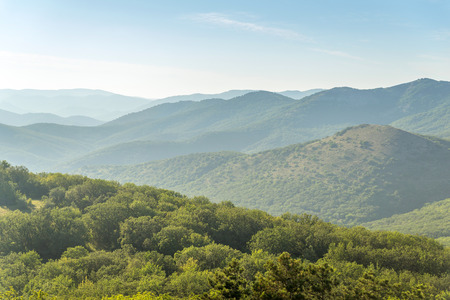 series of mountain hills covered with green forests somewhere in Crimeaの写真素材