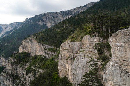 Beautiful landscape. Rocky mountains cliff and blue sky with white cloudsの写真素材