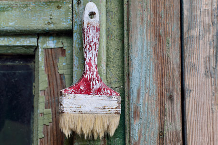 Old brush on the old green wooden backgroundの写真素材