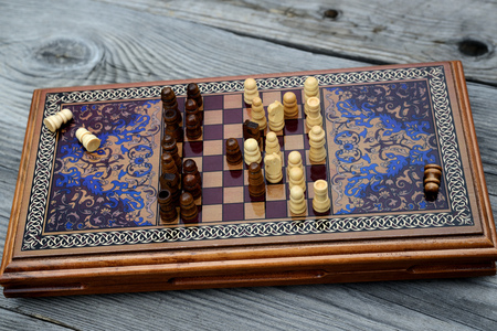 Vintage wooden chess on a wooden chess board. Black and white pieces on the board.の写真素材
