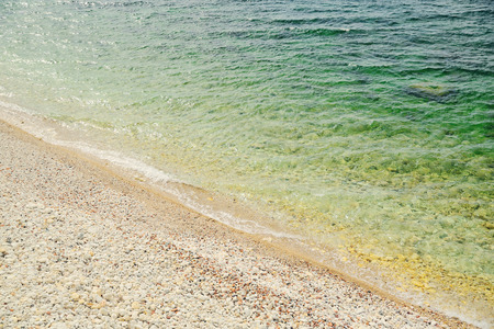Soft sea wave on a sandy beach and pebble beach, top viewの写真素材