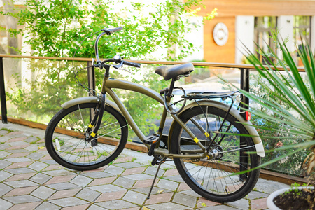 Vintage khaki bike in the sunrise in the courtyard in the old townの写真素材
