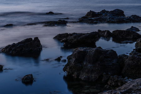 Blue sea landscape at night and waves like haze on long exposureの写真素材