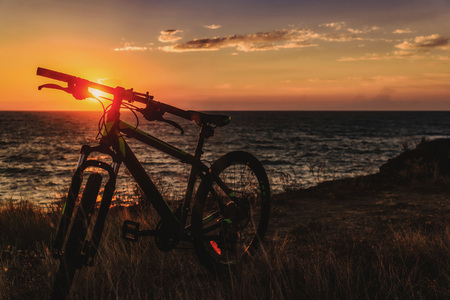 bicycle on the background of the sea at sunsetの写真素材
