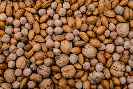 Walnut background, walnut, almonds and hazel on a flat surfaceの写真素材