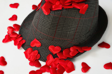 Red decorative hearts scattered on the hat, concept loveの写真素材