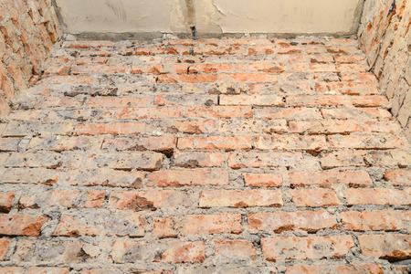 Scraped scratched red brick wallの写真素材