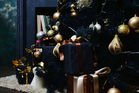 New Year's tree decorated with gold balls with giftsの写真素材