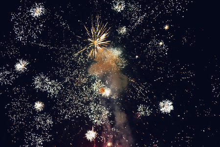 Explosion of diverse fireworks against the night sky on a holiday