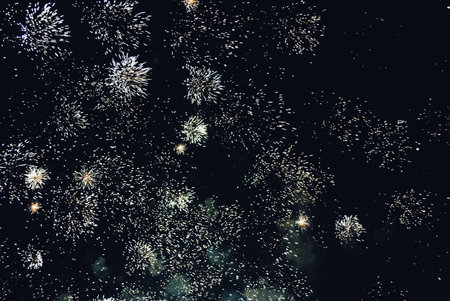 Explosion of diverse fireworks against the night sky on a holiday