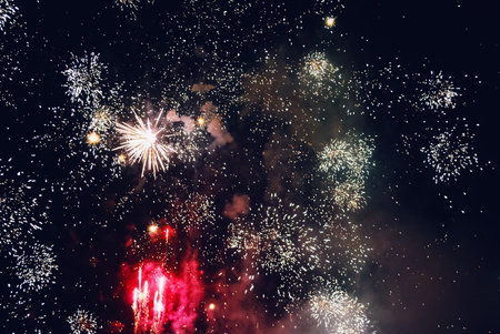 Explosion of diverse fireworks against the night sky on a holiday