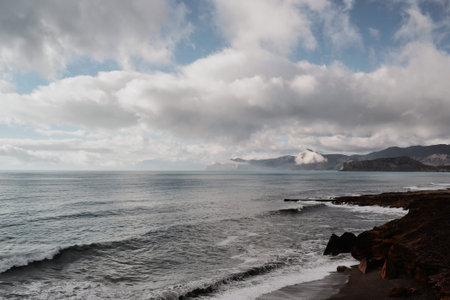Seascape, calm sea and clouds on the mountain coast