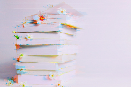 A stack of books in the glitch effect, an art design background, an imitation of video interference on the displayの写真素材
