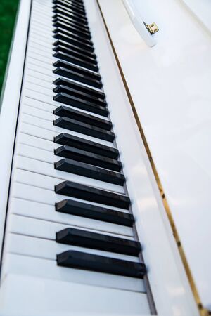 White piano, black and white keys close-upの写真素材