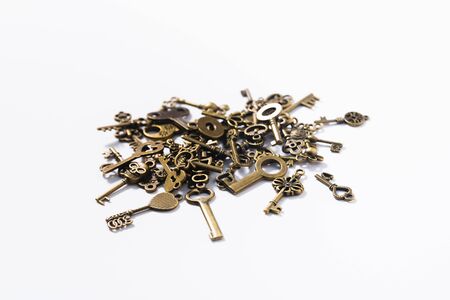 Bunch of diverse door keys on a white backgroundの写真素材