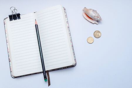 An open lined notebook with a pencil on a white background, concept notes, ideas, organization, diary, listの写真素材