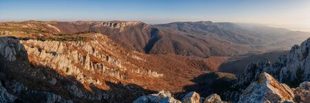 Gorgeous wide panorama of a rocky mountain range in autumn at sunriseの写真素材