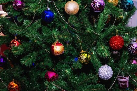 Christmas tree decorated with colored Christmas balls and garlands.の写真素材