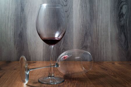 Two large wine glasses on wooden backgroundの写真素材