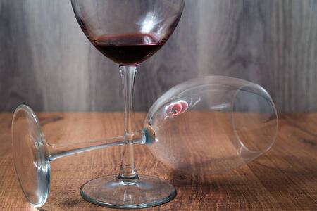 Two large wine glasses on wooden backgroundの写真素材