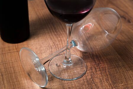 Two large wine glasses on wooden backgroundの写真素材