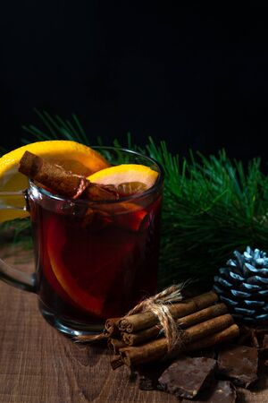 Fragrant mulled wine, spices and tangerines on a Christmas treeの写真素材